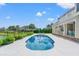 Inviting pool area overlooking a scenic lake, surrounded by lush landscaping and palm trees at 131 Sago Palm Dr., Myrtle Beach, SC 29579