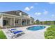This backyard retreat boasts a refreshing pool, a beautiful lake view, and loungers at 131 Sago Palm Dr., Myrtle Beach, SC 29579