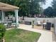 Backyard patio with ample seating, decorative flower pots, rock accents and small lawn at 1504 Saint Thomas Circle, Myrtle Beach, SC 29577