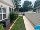Backyard landscape including a garden bed, and concrete path in a fenced in yard at 1504 Saint Thomas Circle, Myrtle Beach, SC 29577