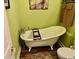 Charming bathroom with a clawfoot tub, vintage faucet, and wood-look flooring at 1504 Saint Thomas Circle, Myrtle Beach, SC 29577