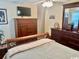 Bedroom with ample dresser storage, TV and decorative mirror with a cozy bed at 1504 Saint Thomas Circle, Myrtle Beach, SC 29577
