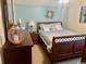 Bedroom with a wood trimmed bed, a decorative nightstand and blue wall color at 1504 Saint Thomas Circle, Myrtle Beach, SC 29577