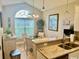 Cozy breakfast nook featuring a granite countertop bar, pendant lighting, and a large bright window at 1504 Saint Thomas Circle, Myrtle Beach, SC 29577
