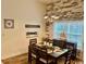 Charming dining room featuring decorative shiplap accent wall, modern chandelier, and a view to the kitchen at 1504 Saint Thomas Circle, Myrtle Beach, SC 29577