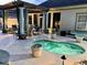 An in-ground hot tub with a covered pergola and outdoor seating at 1504 Saint Thomas Circle, Myrtle Beach, SC 29577
