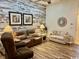 Comfortable living room features wood-look floors, reclining leather furniture, and stylish decor at 1504 Saint Thomas Circle, Myrtle Beach, SC 29577