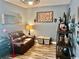 Inviting living room featuring a leather sofa, unique decor, and hardwood flooring at 1504 Saint Thomas Circle, Myrtle Beach, SC 29577