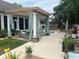 An outdoor patio with a pergola, seating, a hot tub, and lush landscaping at 1504 Saint Thomas Circle, Myrtle Beach, SC 29577