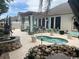 A beautifully landscaped patio with a hot tub, pergola, and rock water feature at 1504 Saint Thomas Circle, Myrtle Beach, SC 29577