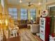 Relaxing sunroom with ample natural light, comfortable seating, and unique vintage decor at 1504 Saint Thomas Circle, Myrtle Beach, SC 29577