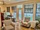 Inviting sunroom features comfortable seating, natural light, and vintage decor at 1504 Saint Thomas Circle, Myrtle Beach, SC 29577