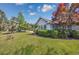 Serene backyard showcasing lush greenery, a patio, and well-maintained lawn at 1527 Hallborough Dr., Surfside Beach, SC 29575