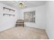 Well-lit bedroom featuring neutral carpet, a large window, and simple shelving at 1527 Hallborough Dr., Surfside Beach, SC 29575