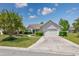 Attractive home featuring a two-car garage and a well-maintained lawn with mature trees at 1527 Hallborough Dr., Surfside Beach, SC 29575