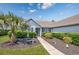 Beautiful home exterior with lush greenery, a walkway, and mature palm trees in a manicured garden at 1527 Hallborough Dr., Surfside Beach, SC 29575