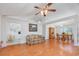 Open-concept living area featuring wood floors, a ceiling fan, and seamless flow into the dining room at 1527 Hallborough Dr., Surfside Beach, SC 29575