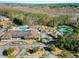 Aerial view of a community featuring tennis courts, a pool, clubhouse, and surrounding forest at 1631 Murrell Pl., Murrells Inlet, SC 29576
