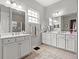This bathroom features dual sinks, a window and lots of storage at 1631 Murrell Pl., Murrells Inlet, SC 29576