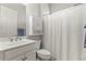 This bathroom features a single sink, shower with a curtain, and medicine cabinet at 1631 Murrell Pl., Murrells Inlet, SC 29576