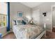 This bedroom features a patterned quilt, a bright window and a closet at 1631 Murrell Pl., Murrells Inlet, SC 29576