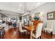 Open concept dining area with fireplace, wooden floors, and a modern chandelier at 1631 Murrell Pl., Murrells Inlet, SC 29576