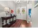 Elegant foyer with hardwood floors, decorative console table, and double doors adorned with wreaths at 1631 Murrell Pl., Murrells Inlet, SC 29576