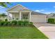Charming single-story home with a manicured lawn, attached garage, and inviting front porch at 1631 Murrell Pl., Murrells Inlet, SC 29576