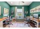 Inviting home office featuring dual workspaces, a comfortable loveseat, and calming green walls at 1631 Murrell Pl., Murrells Inlet, SC 29576
