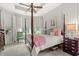 This main bedroom boasts a four-poster bed, tray ceilings, and multiple windows at 1631 Murrell Pl., Murrells Inlet, SC 29576