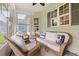 Enclosed porch with ceiling fan, plenty of natural light, and cozy wicker furniture at 1631 Murrell Pl., Murrells Inlet, SC 29576