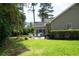 Expansive backyard with lush greenery, a patio, and mature trees at 170 Glenwood Dr., Conway, SC 29526
