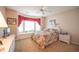 Well lit bedroom includes a large bay window with window seating, a ceiling fan, and carpeted floors at 170 Glenwood Dr., Conway, SC 29526