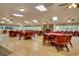 Large dining room with wood floors, a stone fireplace, and red chairs and tables at 170 Glenwood Dr., Conway, SC 29526