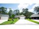 View of the exterior of the house with a long driveway and meticulously maintained lawn and mature trees at 170 Glenwood Dr., Conway, SC 29526