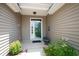 Inviting front porch featuring a glass paneled door, decorative plants and a bench for relaxing at 170 Glenwood Dr., Conway, SC 29526