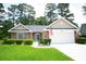 Charming single-story home featuring a brick facade, well-manicured lawn and attached two car garage at 170 Glenwood Dr., Conway, SC 29526