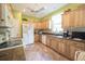 A well-lit kitchen featuring wood cabinets, modern appliances, and ample counter space for culinary endeavors at 170 Glenwood Dr., Conway, SC 29526