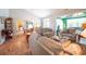 Bright living room with wood floors, a vaulted ceiling, and a clear view into the open kitchen at 170 Glenwood Dr., Conway, SC 29526