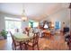 Open-concept living area with wood floors, dining table, and plenty of natural light from sliding glass doors at 170 Glenwood Dr., Conway, SC 29526