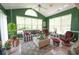 Comfortable sun room with vaulted ceilings, lots of windows, and a cozy seating arrangement at 170 Glenwood Dr., Conway, SC 29526