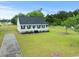 Aerial view of the home showcasing the well-maintained lawn, classic architecture, and black roof at 1763 Lipscomb Rd., Mullins, SC 29574
