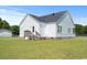 Exterior view of the home featuring a small deck and backyard with chain link fence at 1763 Lipscomb Rd., Mullins, SC 29574
