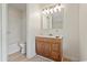 Bathroom with wood vanity, mirror, and shower-tub combo at 1763 Lipscomb Rd., Mullins, SC 29574