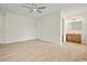 Bedroom with wood-look flooring leads to bathroom with wooden vanity at 1763 Lipscomb Rd., Mullins, SC 29574