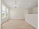 Bright dining room featuring light wood floors and a stylish chandelier at 1763 Lipscomb Rd., Mullins, SC 29574