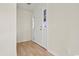 Bright entryway featuring wood-look floors, a white front door, and neutral wall paint at 1763 Lipscomb Rd., Mullins, SC 29574