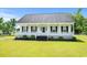 Charming single-story home featuring a welcoming front porch and well-manicured lawn at 1763 Lipscomb Rd., Mullins, SC 29574