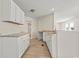 Bright kitchen featuring white cabinets, light countertops, and light wood floors at 1763 Lipscomb Rd., Mullins, SC 29574