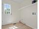 Well-lit laundry room with white walls, shelving, and an exterior door at 1763 Lipscomb Rd., Mullins, SC 29574